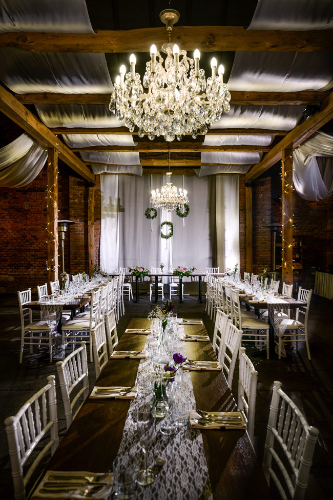 wedding reception inside the barn with chandeliers at dvur hoffmeister 