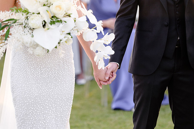 bride and groom holding hands