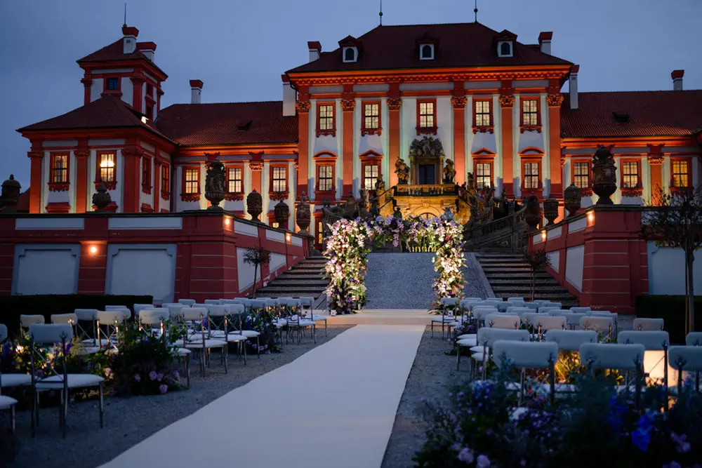 Troja Chateau Prague outdoor wedding ceremony setup at night.