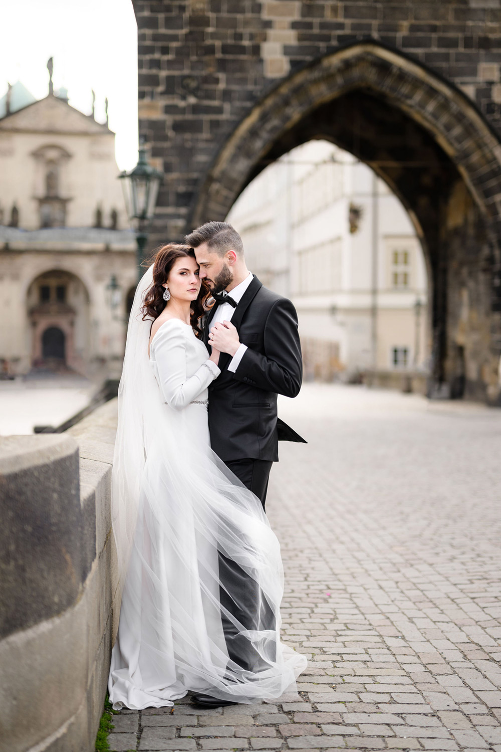 Bride and groom on Charles Bridge in Prague