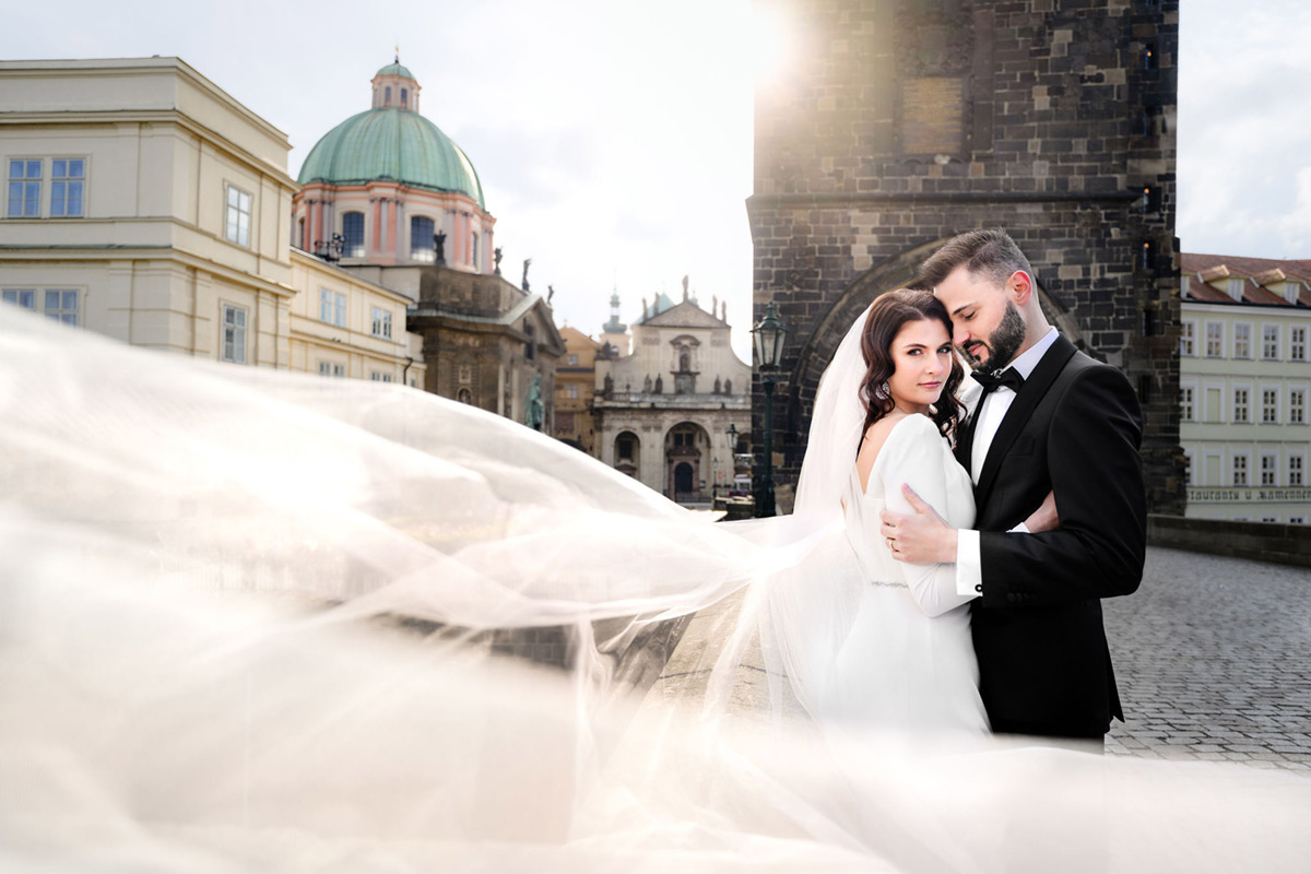 Bride and groom at Charles bridge in Prague