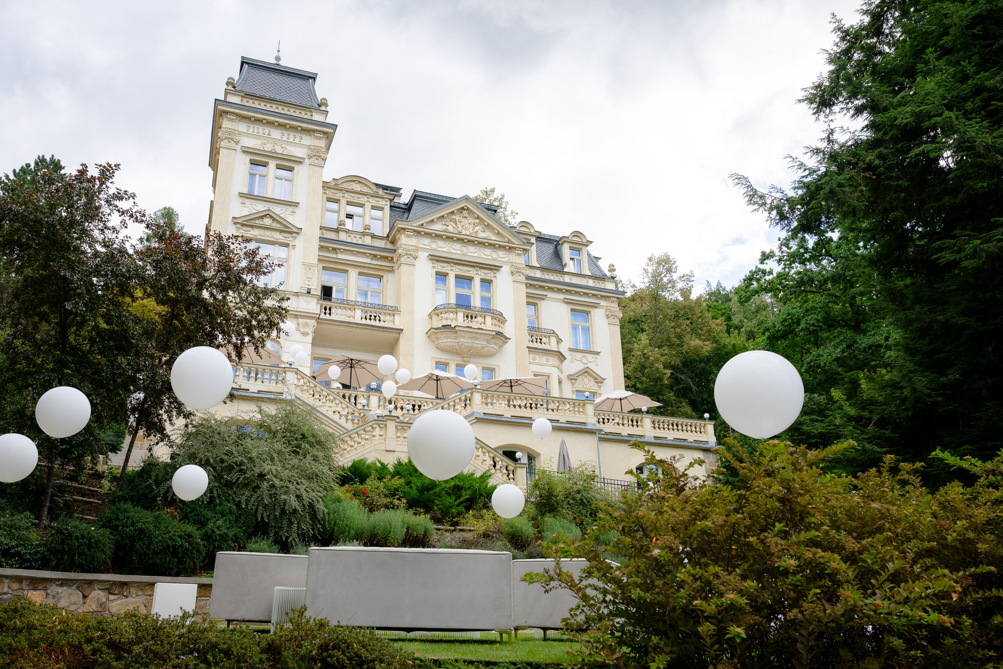 Elegant Villa Julius & Emma in Karlovy Vary decorated with white balloons for fashion designer Debbie Brown’s wedding.