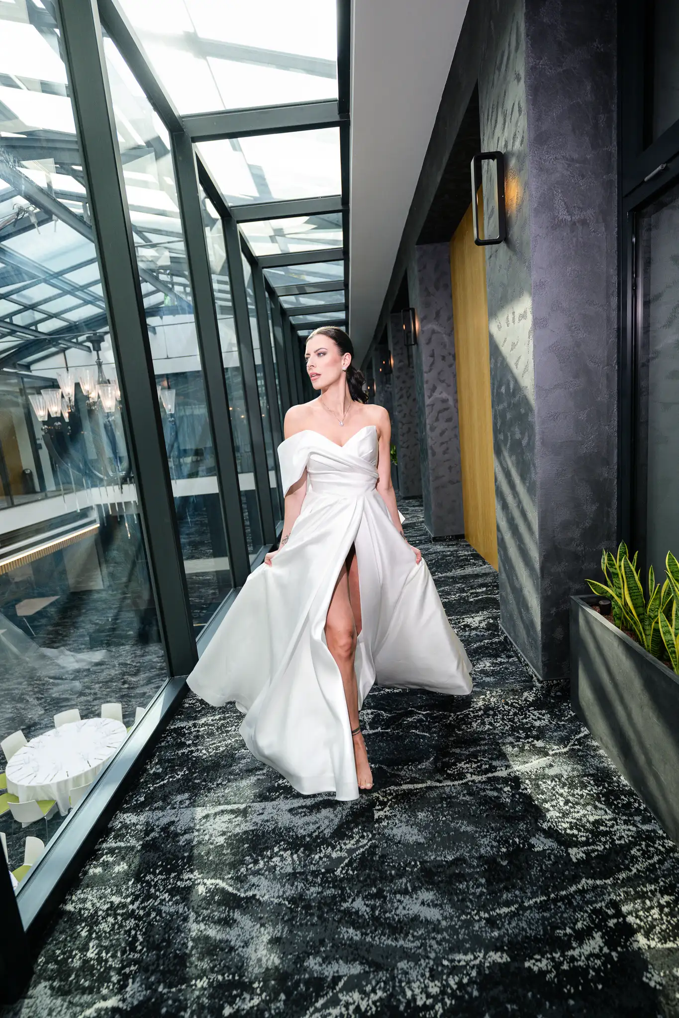 B&W photo of a laughing couple in an elevator. Minimalist dress, tuxedo. Wedding editorial Hotel Passage Brno. By: Jindrich Nejedly