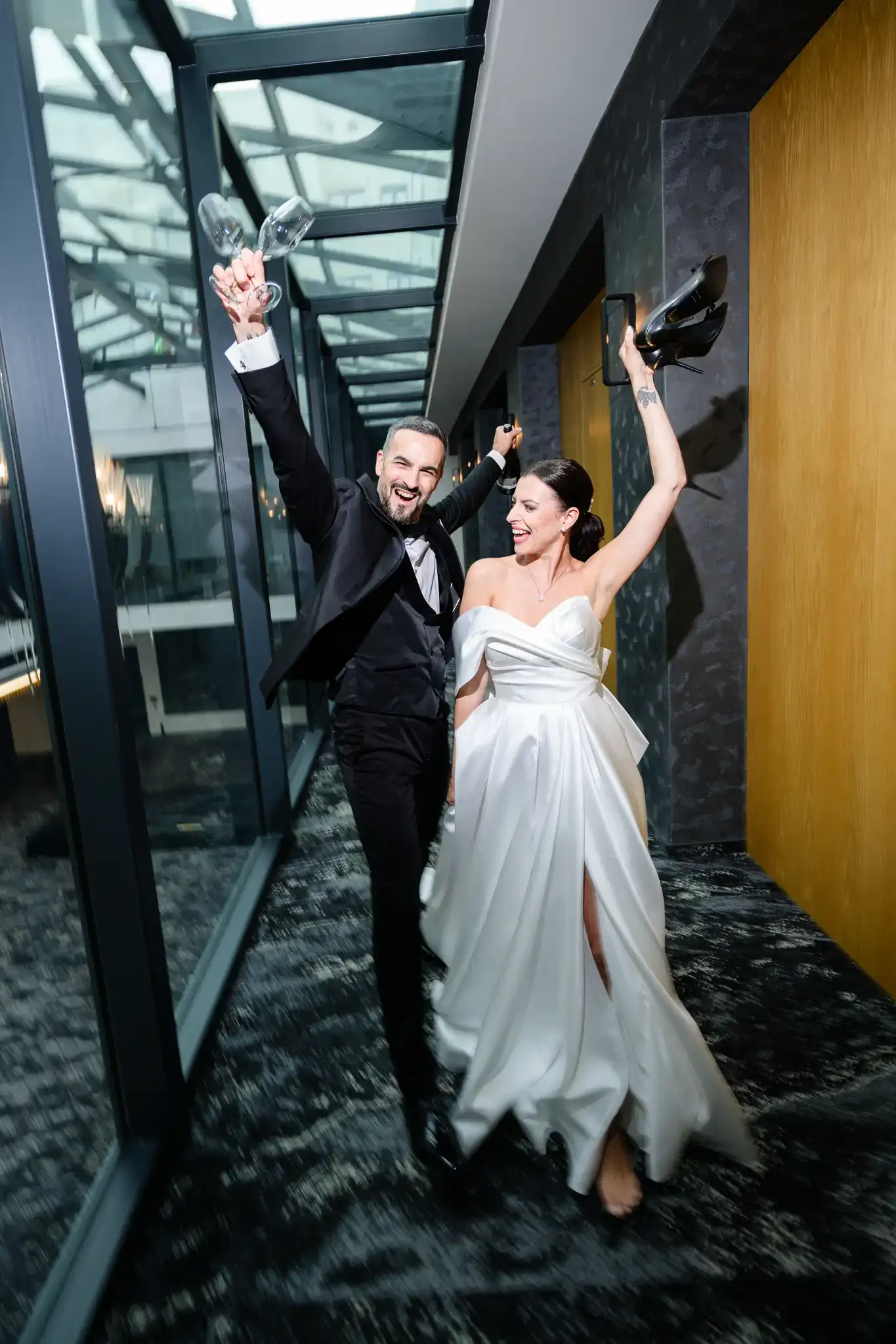 Dynamic portrait of newlyweds embracing by a window. Brutalist modern design, editorial Hotel Passage Brno.