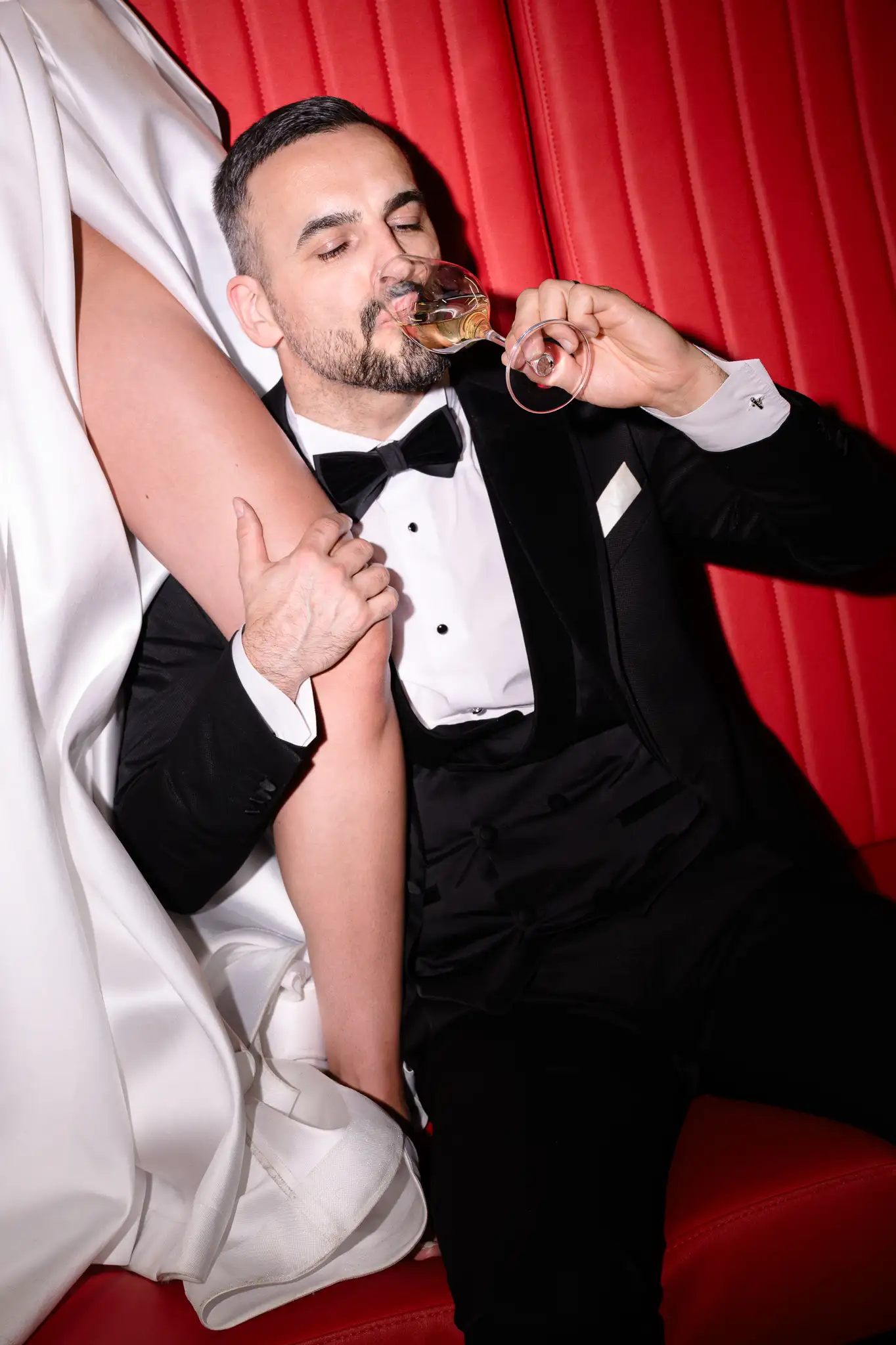 Portrait of groom in luxury tuxedo at the bar. Modern wedding editorial Czech Republic