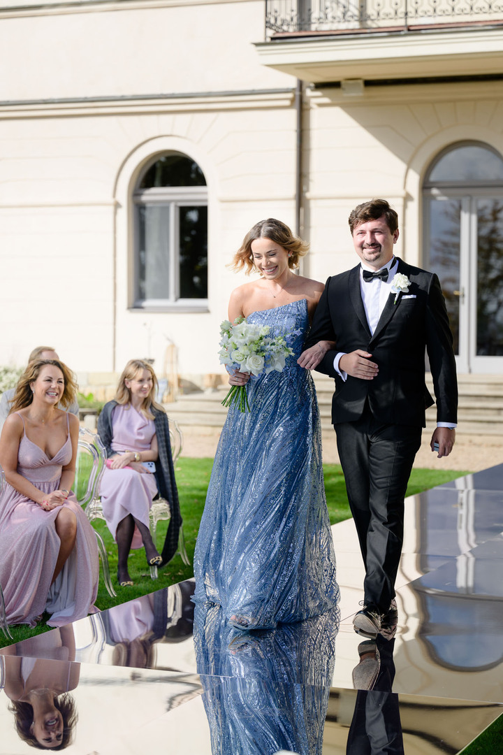 couple walking on mirror stage at chateau mcely