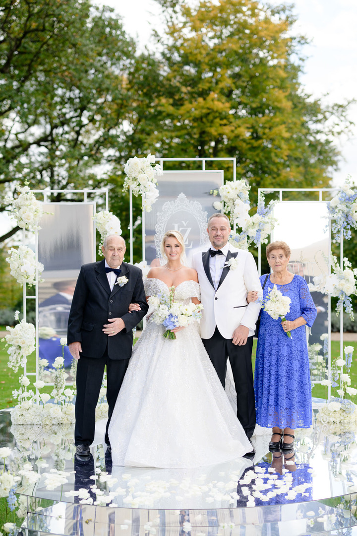 Bride and groom with parents at a luxurious Chateau Mcely wedding ceremony.