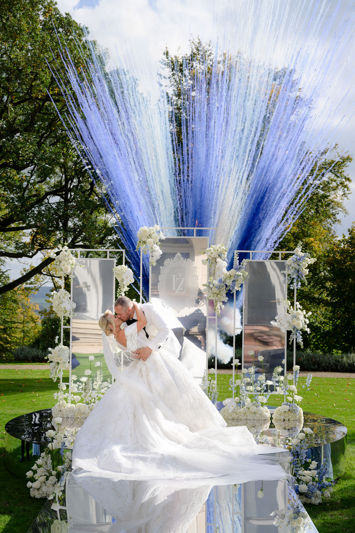 Wedding at Chateau Mcely where bride and groom share their first kiss with a spectacular blue and white firework display.