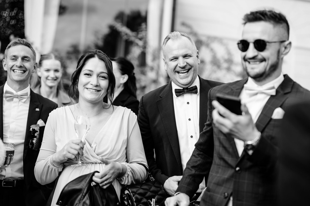 Joyful wedding guests celebrating with smiles and laughter at the luxurious Chateau Mcely wedding venue.