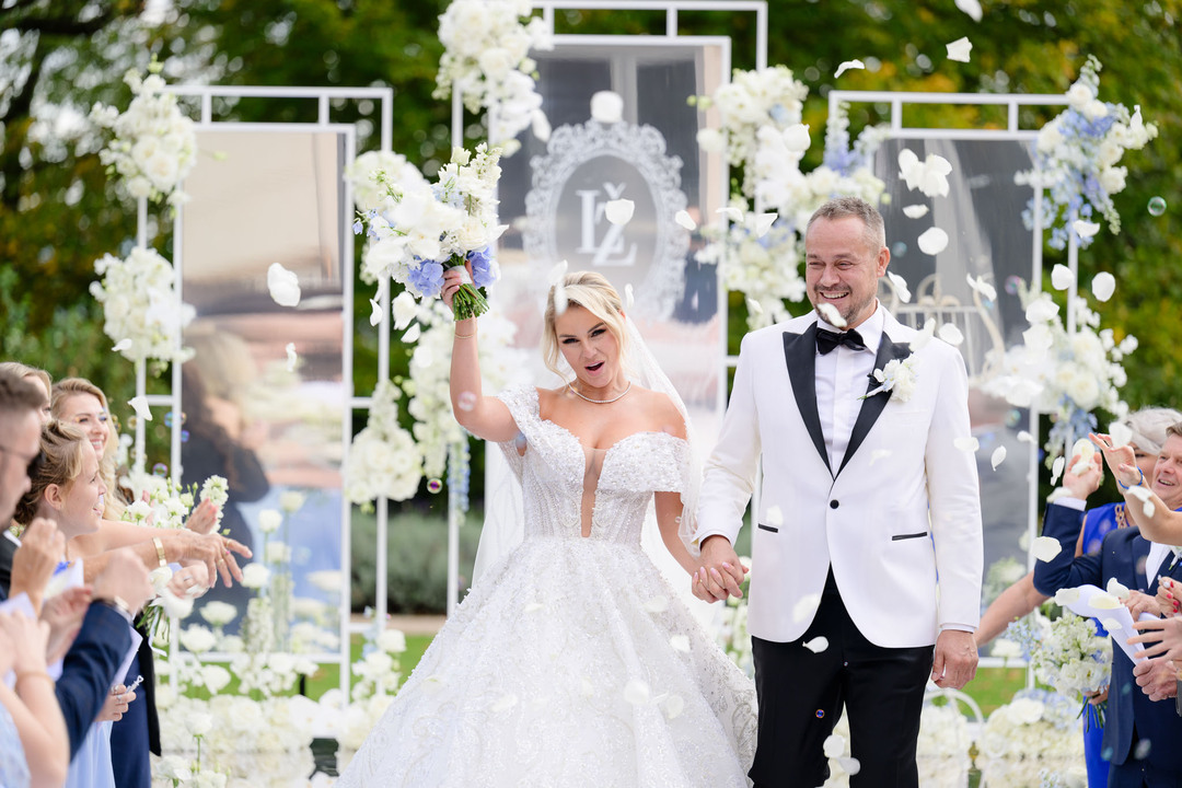 Joyful bride and groom celebrating their wedding at Chateau Mcely.