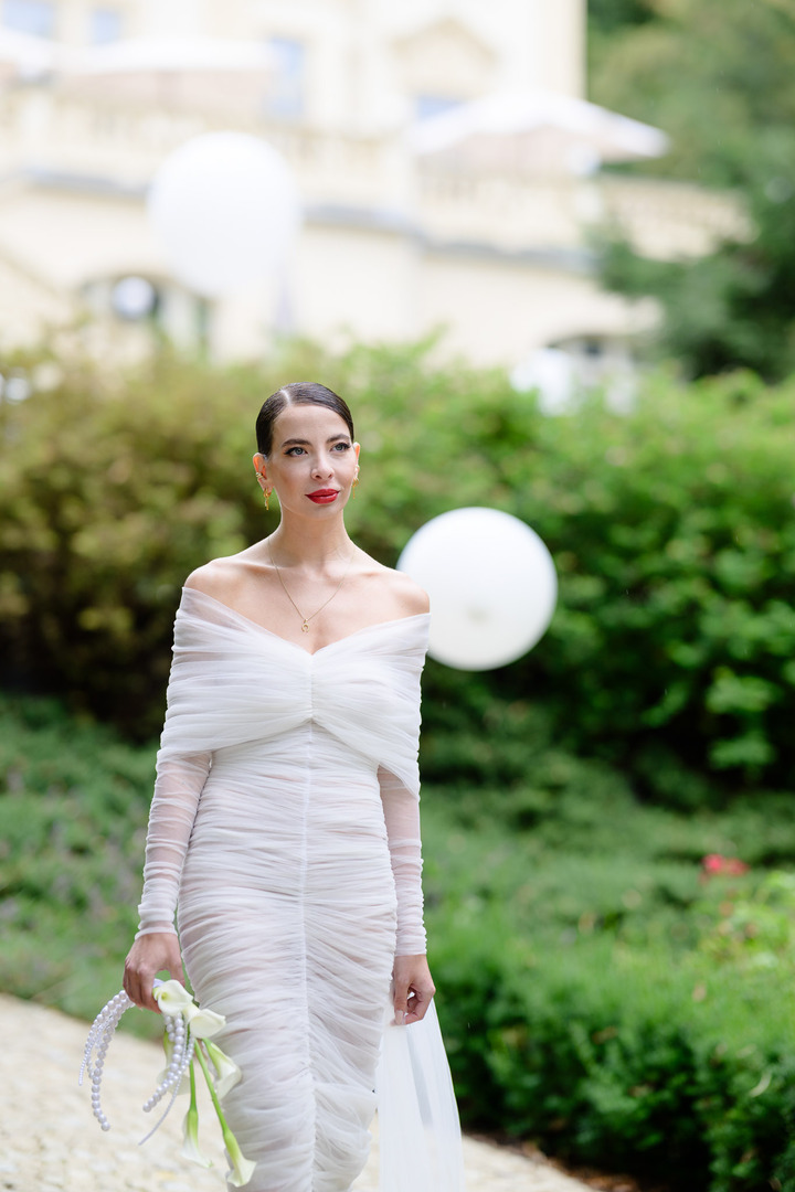 The bride and fashion designer Debbie Brown in her white dress walk down the aisle to the altar.
