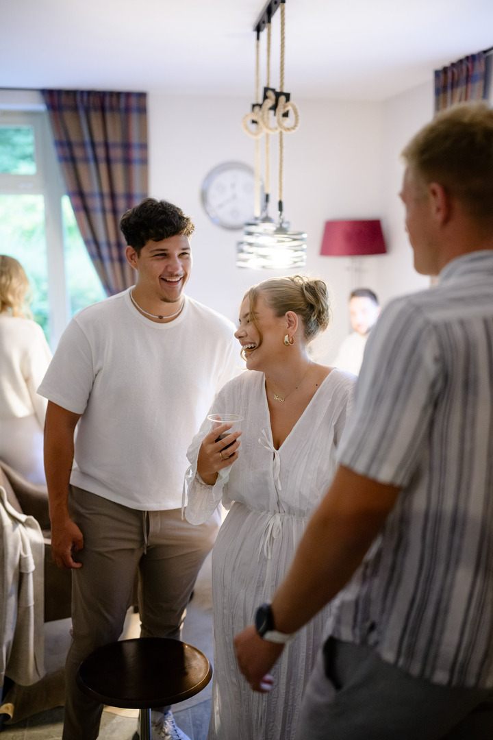 Guests laugh and chat during the celebration inside the villa Julius & Emma P.
