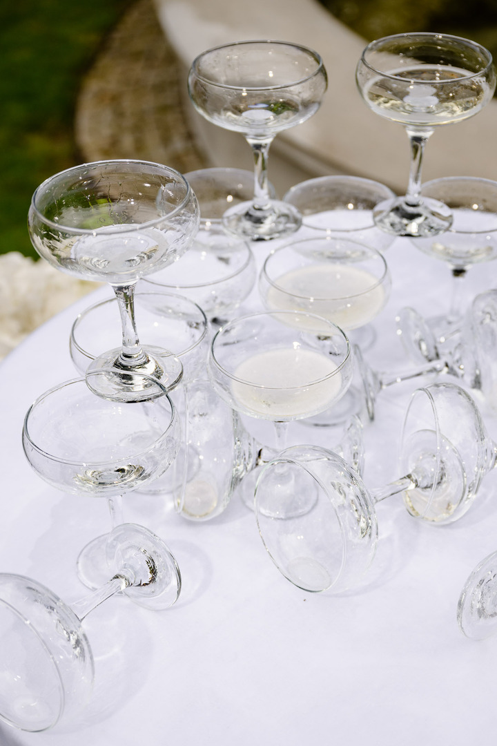 The wedding champagne tower couldn't withstand the pouring of the toast and collapsed. The photo shows fallen glasses and spilled champagne.
