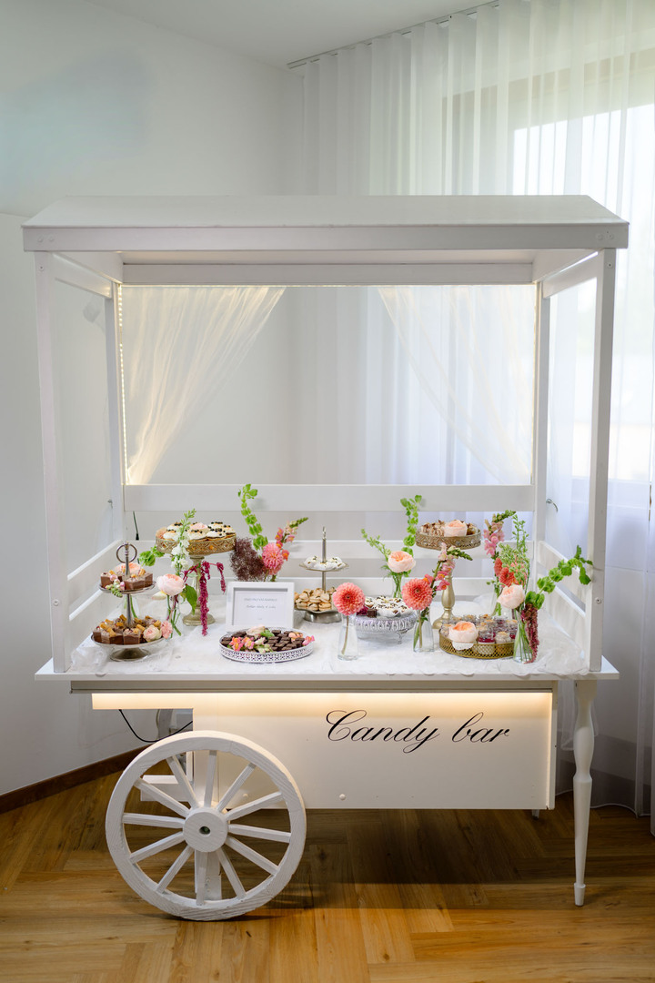 Sweet bar with a cart full of treats prepared for wedding guests at Hotel & Garden U Holubů in Čeladná.
