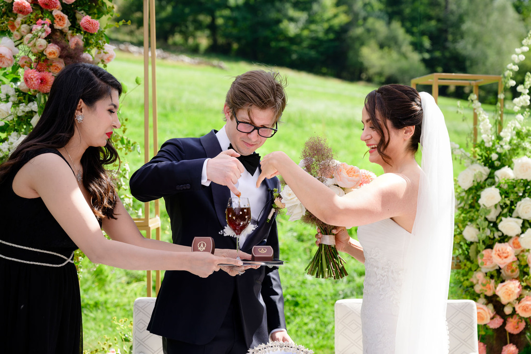 Bride and groom follow Persian wedding traditions, dipping their little fingers into honey.
