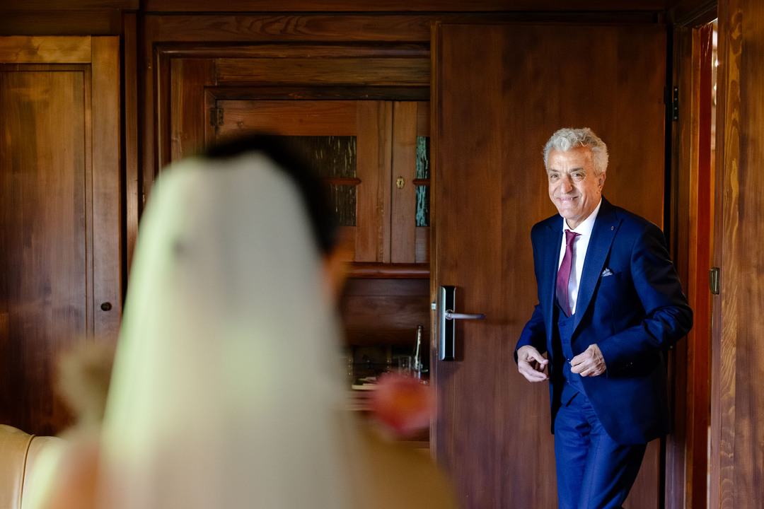 The bride’s father looking into the room and searching for his daughter during a wedding in Čeladná.
