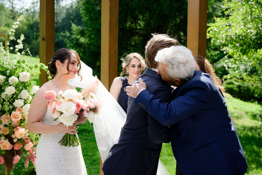 Congratulations to the newlyweds, the bride’s father embracing his new son at Hotel & Garden U Holubů.
