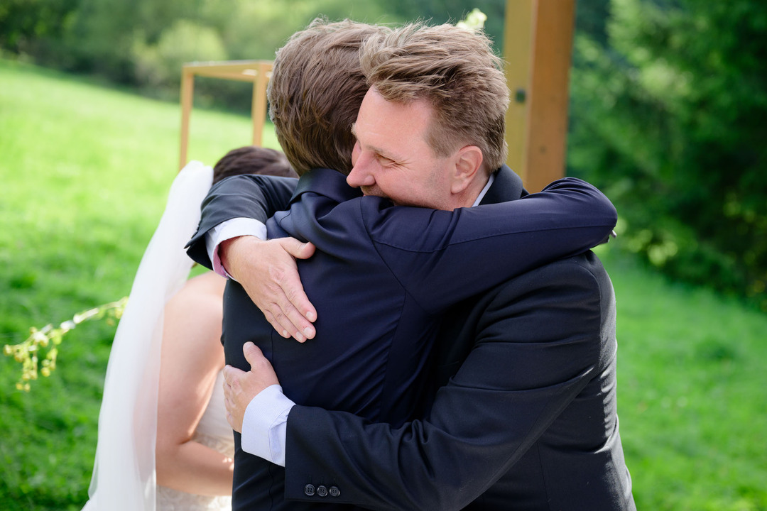 Wedding guests congratulating the newlyweds.