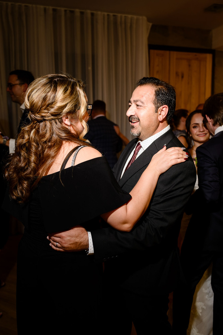 Wedding guests dancing and celebrating in the evening reception hall at U Holubů.