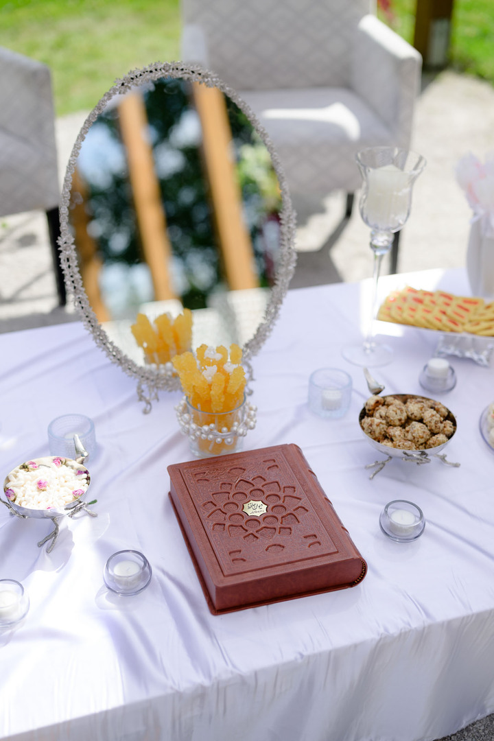 Ceremonial table full of symbolism in Persian style during an outdoor wedding ceremony in Čeladná.
