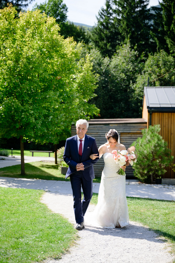 The bride walking down the aisle with her father, photographed by Jindřich Nejedlý.