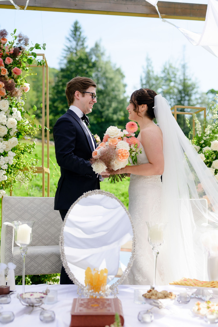 Czech-Persian wedding in Čeladná, the bride and groom smiling lovingly at each other, photographed by Jindřich Nejedlý.
