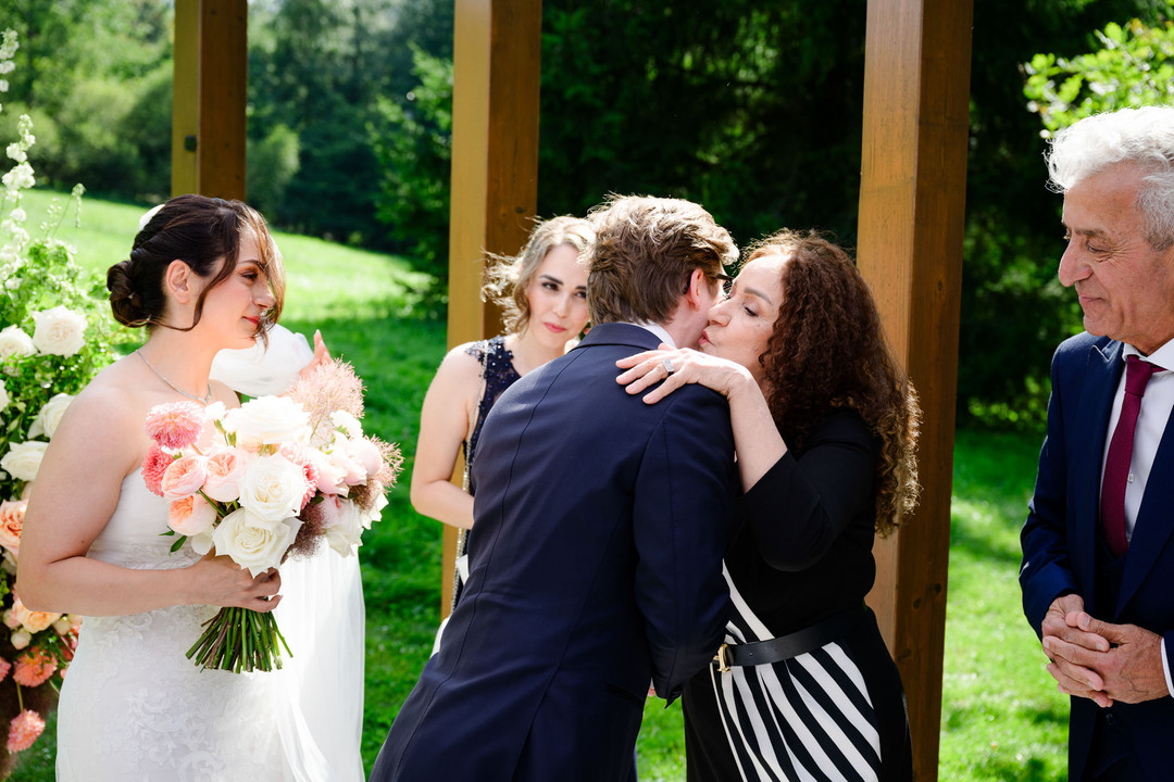 The bride’s mother warmly congratulates the groom.
