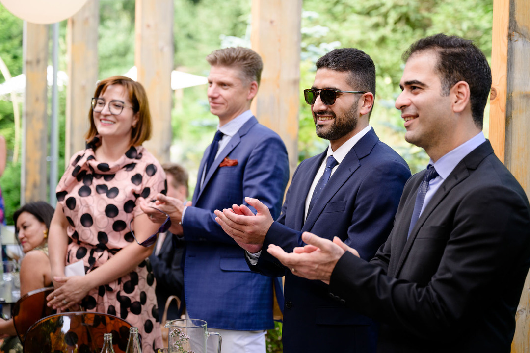 Wedding guests applauding the newlyweds during a wedding in the Beskydy.
