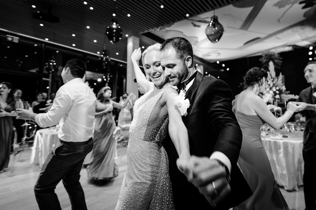 A couple dances joyfully at a wedding celebration at Obelisk Winery.