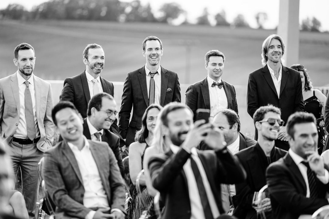 Wedding guests are smiling during the ceremony at Obelisk Winery.