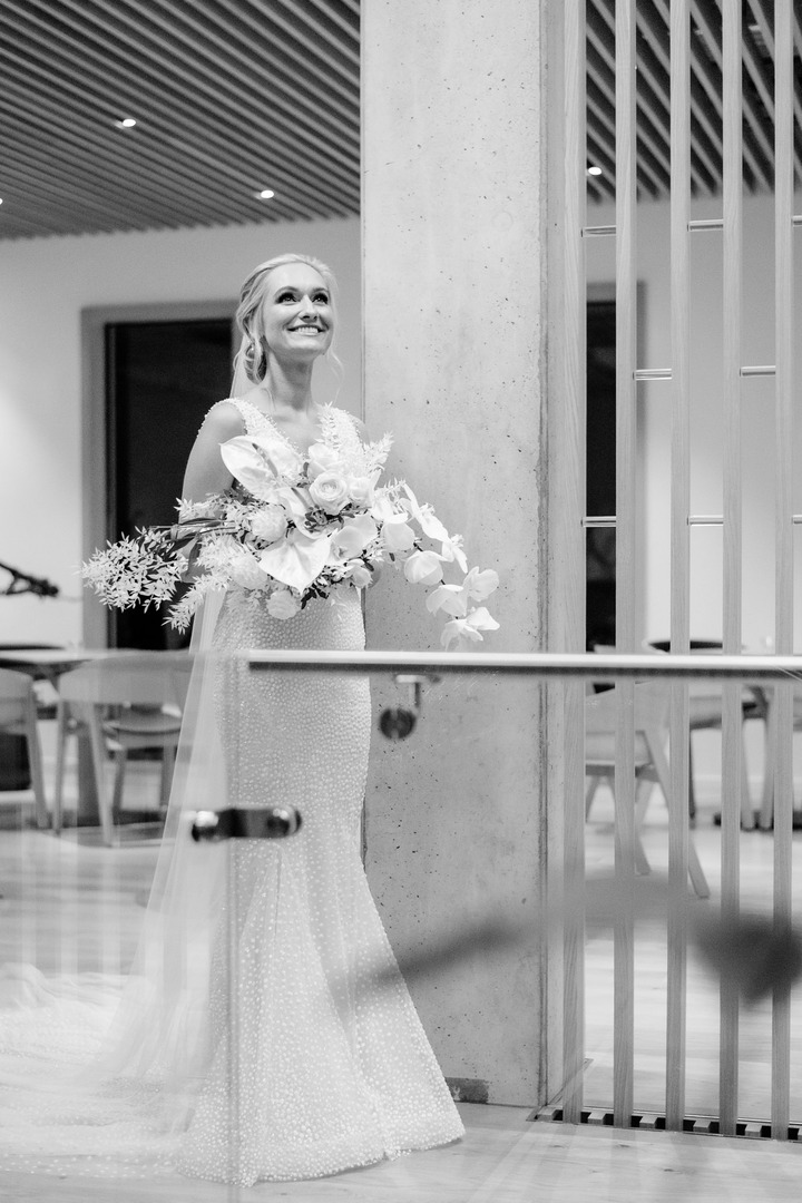 Bride holding a bouquet of flowers, smiling before the wedding ceremony at Obelisk Winery.