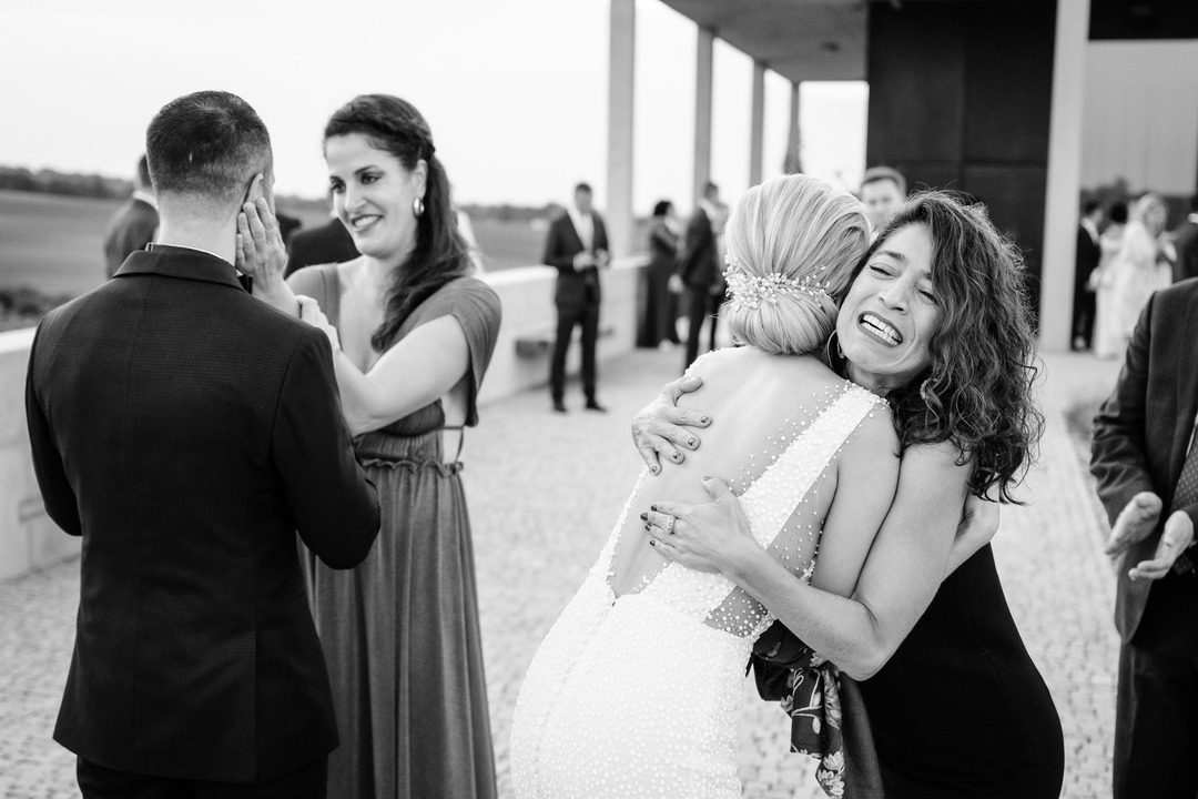 The newlyweds' friends happily and emotionally congratulate them.