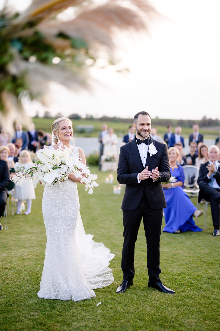 The groom claps during the ceremony in response to the best man's speech.