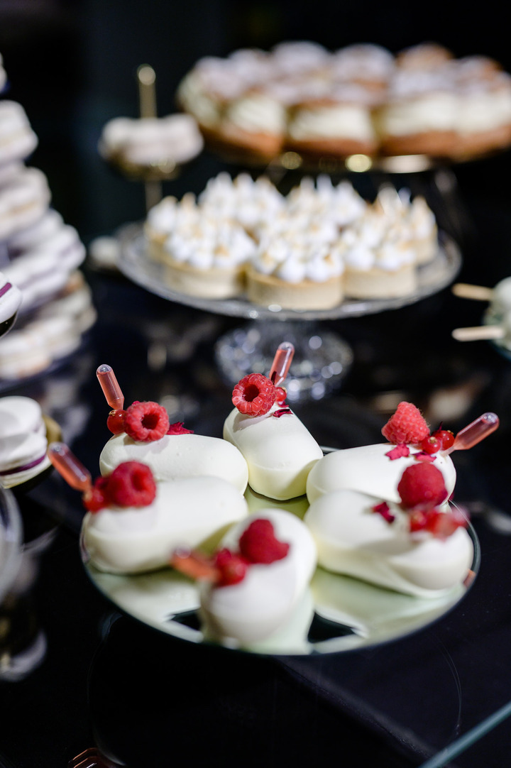 Wedding dessert decorated with raspberries and currants.