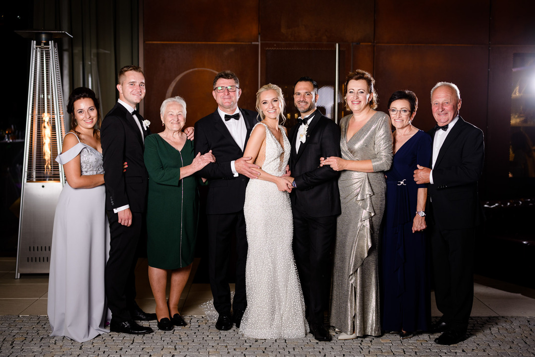 Wedding party posing for a formal group photo in elegant attire.