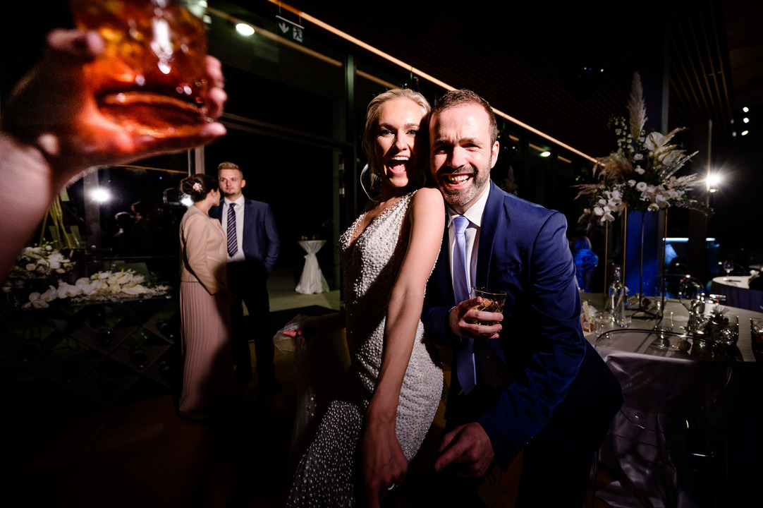 The bride happily dances and poses with a friend.