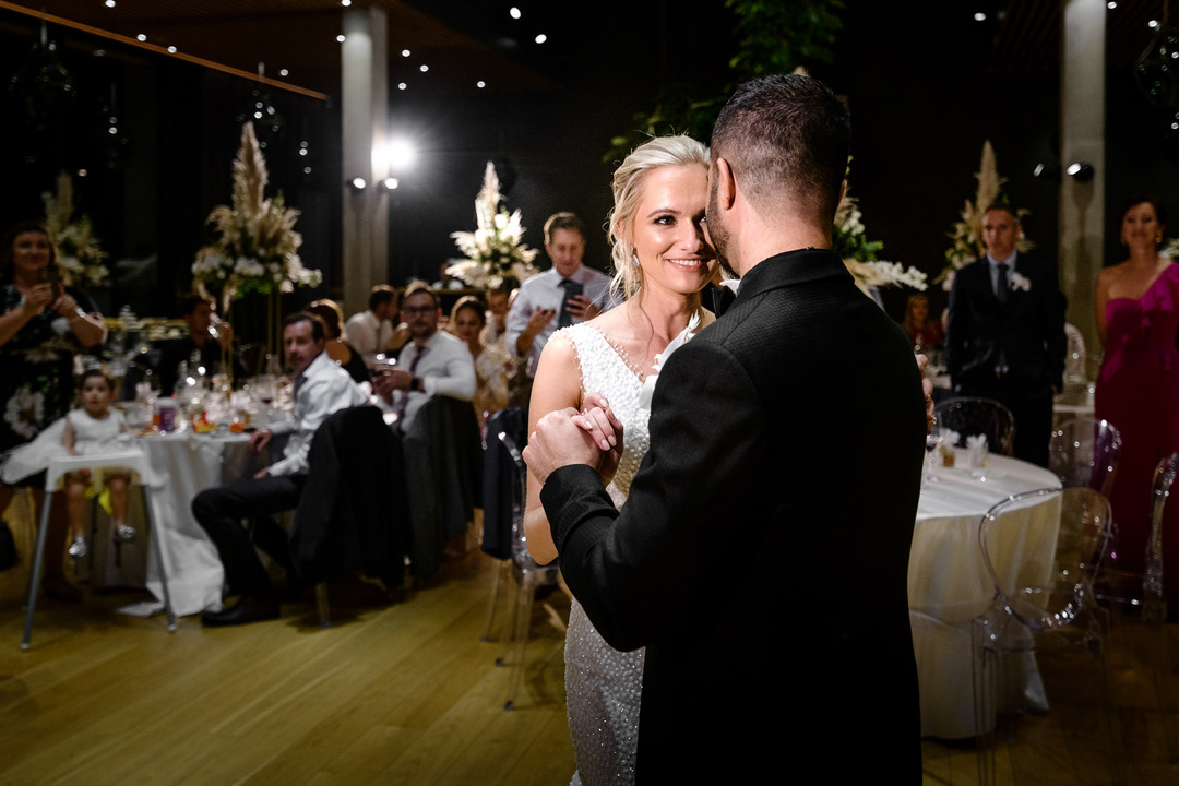 A beautiful moment captured as the bride and groom dance together at their elegant wedding reception.
