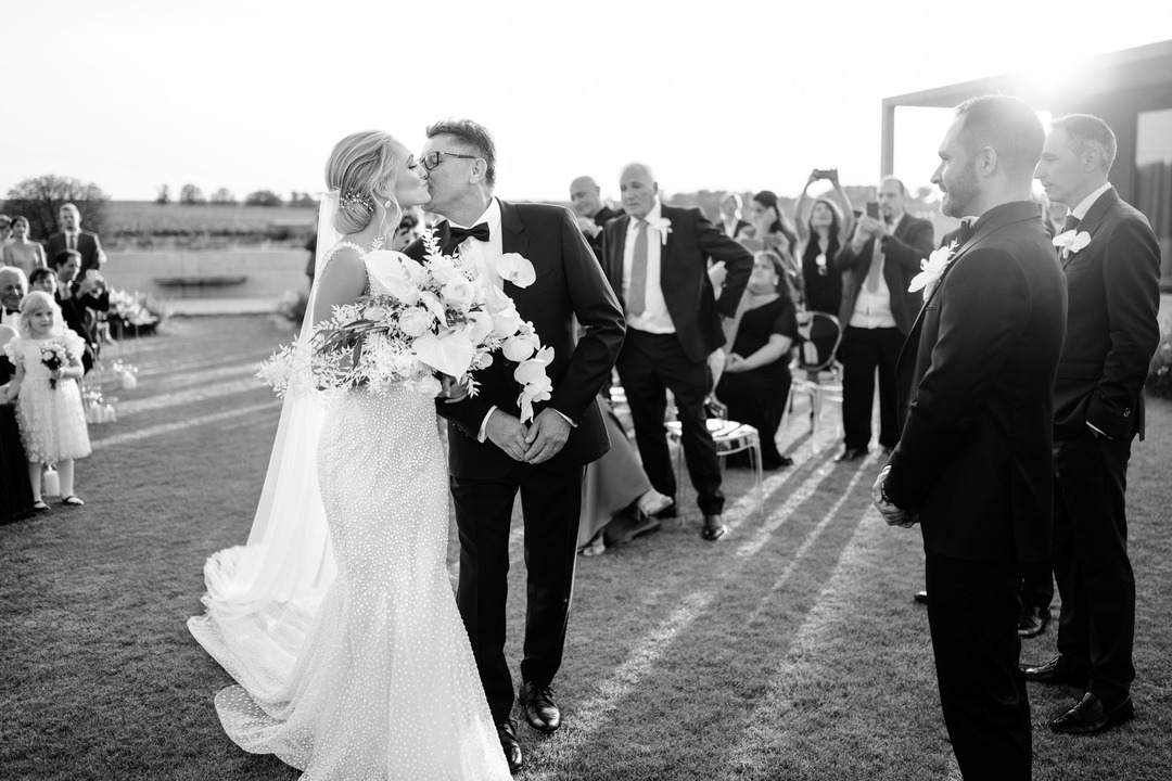 Father kiss his daughter on the wedding day.