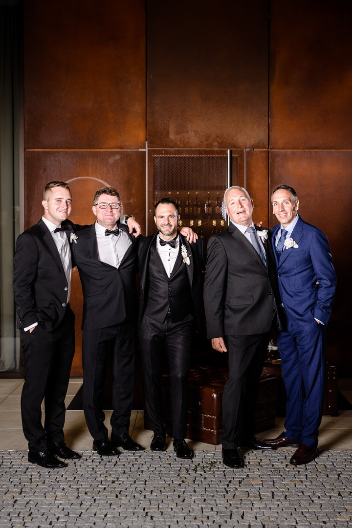 Groom with groomsmen in formal attire at Obelisk Winery wedding.