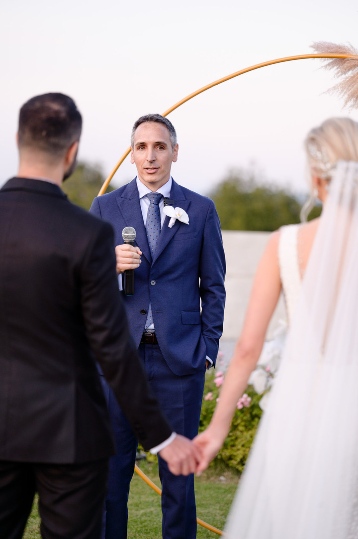 Groom's brother and best man delivers a heartfelt speech with a microphone at Obelisk Winery wedding.