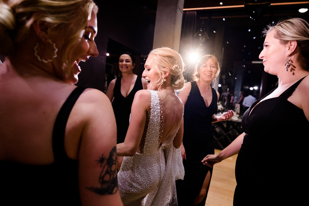 The bride dances on the dance floor with other women.