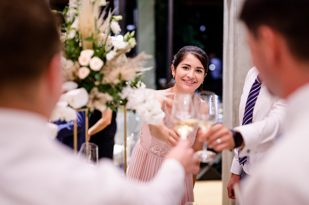 Wedding guests at Obelisk Winery enjoying the evening with glasses raised, sharing laughter and joy. 