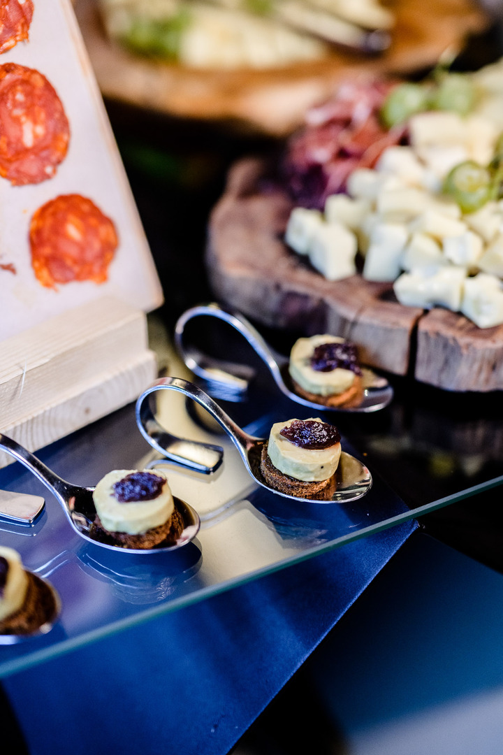 Elegant appetizers served on spoons at a wedding reception.