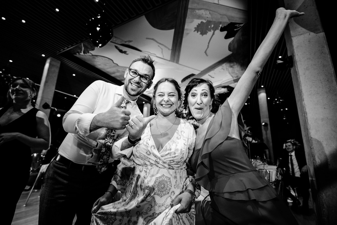  A group of friends pose together, smiling and enjoying the wedding festivities.