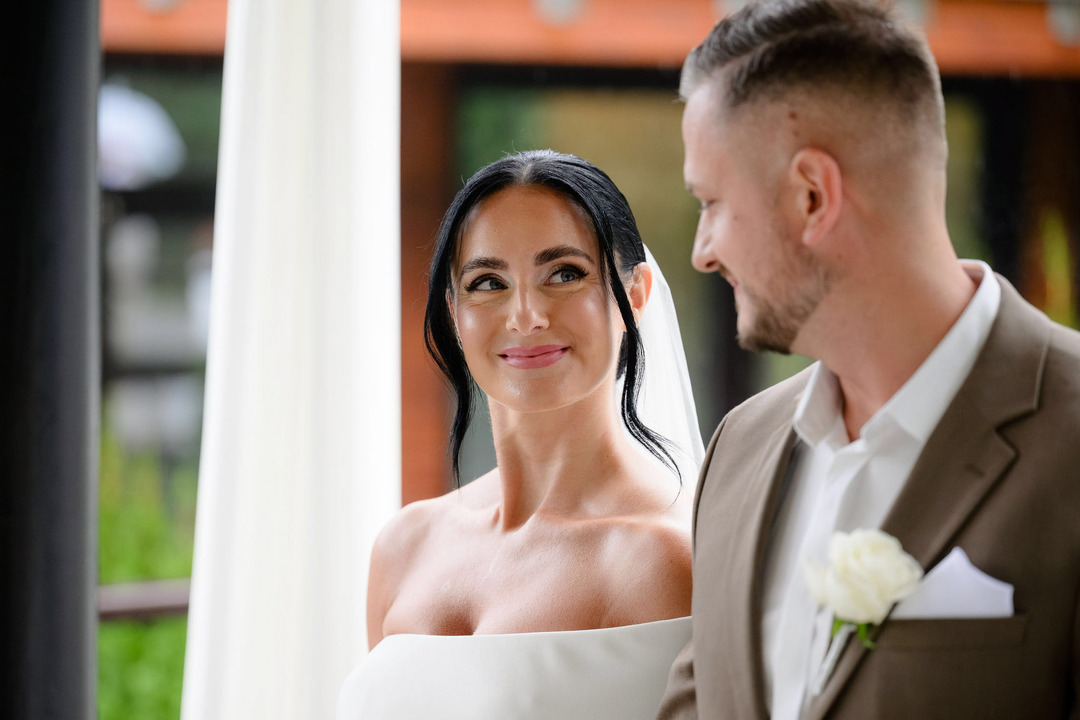 The bride and groom gaze at each other lovingly during the ceremony.
