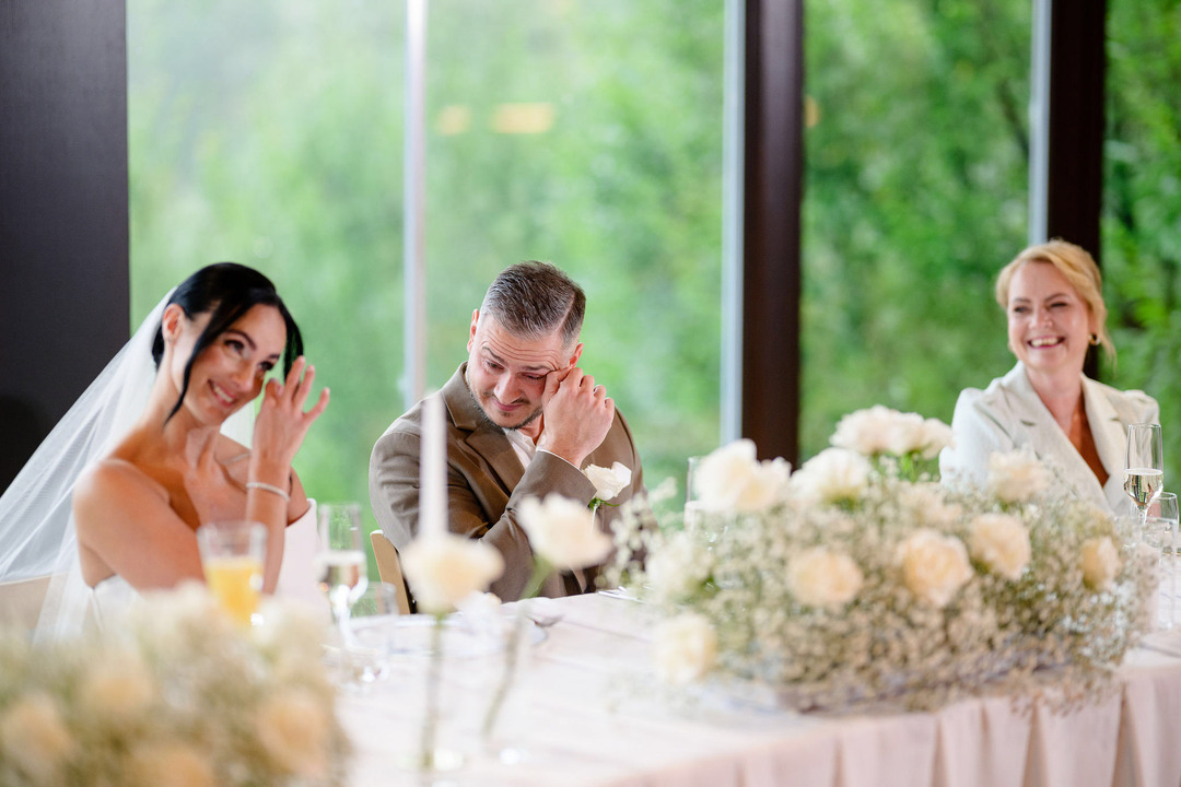 During the best man's speech, both the bride and groom wipe away tears of emotion.
