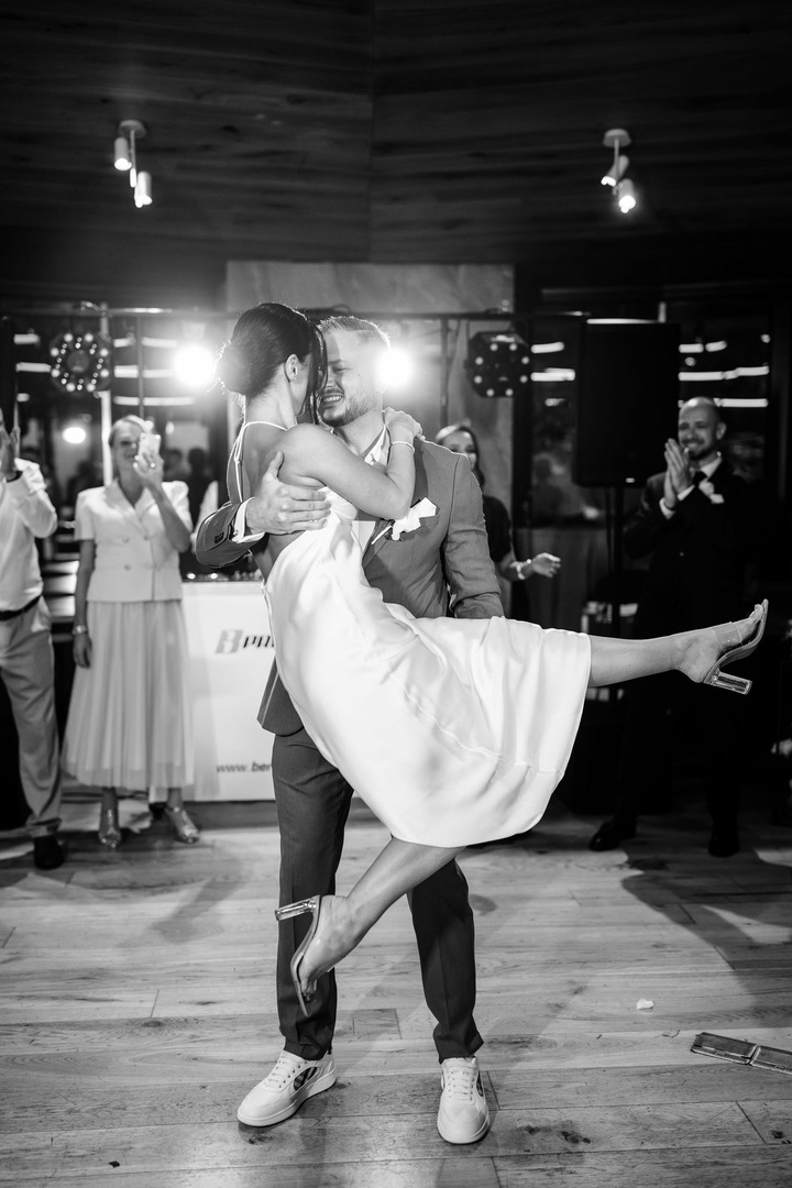 The couple's first dance, the groom lifts the bride into the air and spins her around.
