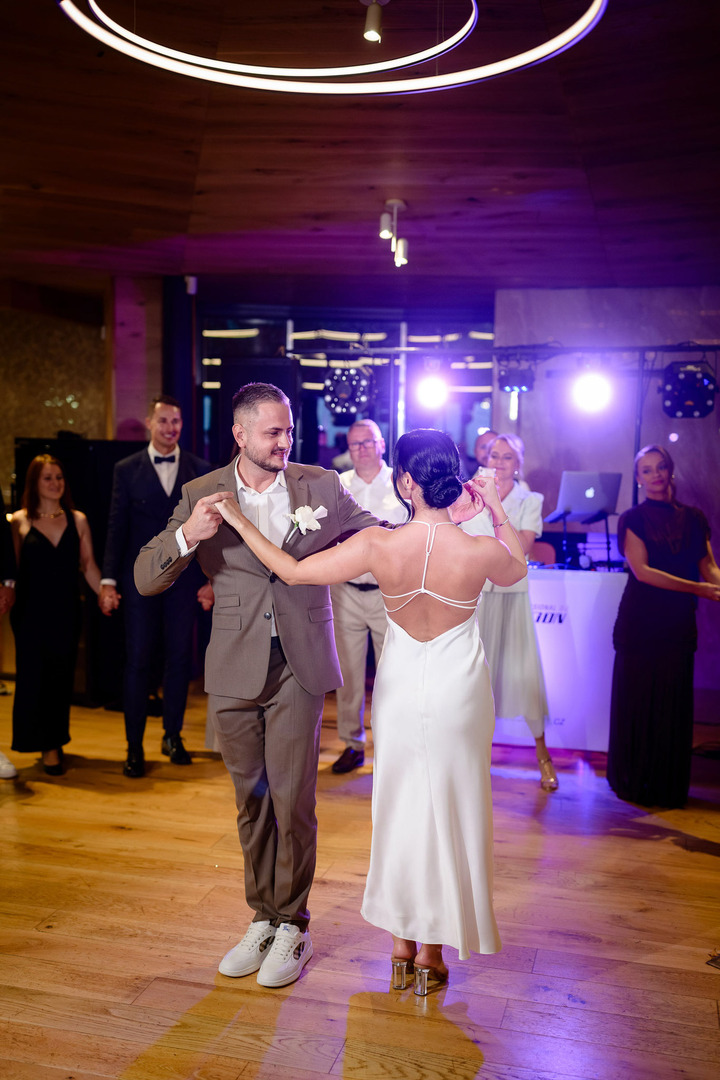 Newlyweds enjoying their first dance as a married couple, surrounded by the attention of guests in the elegant hall of Villa Cattaleya.