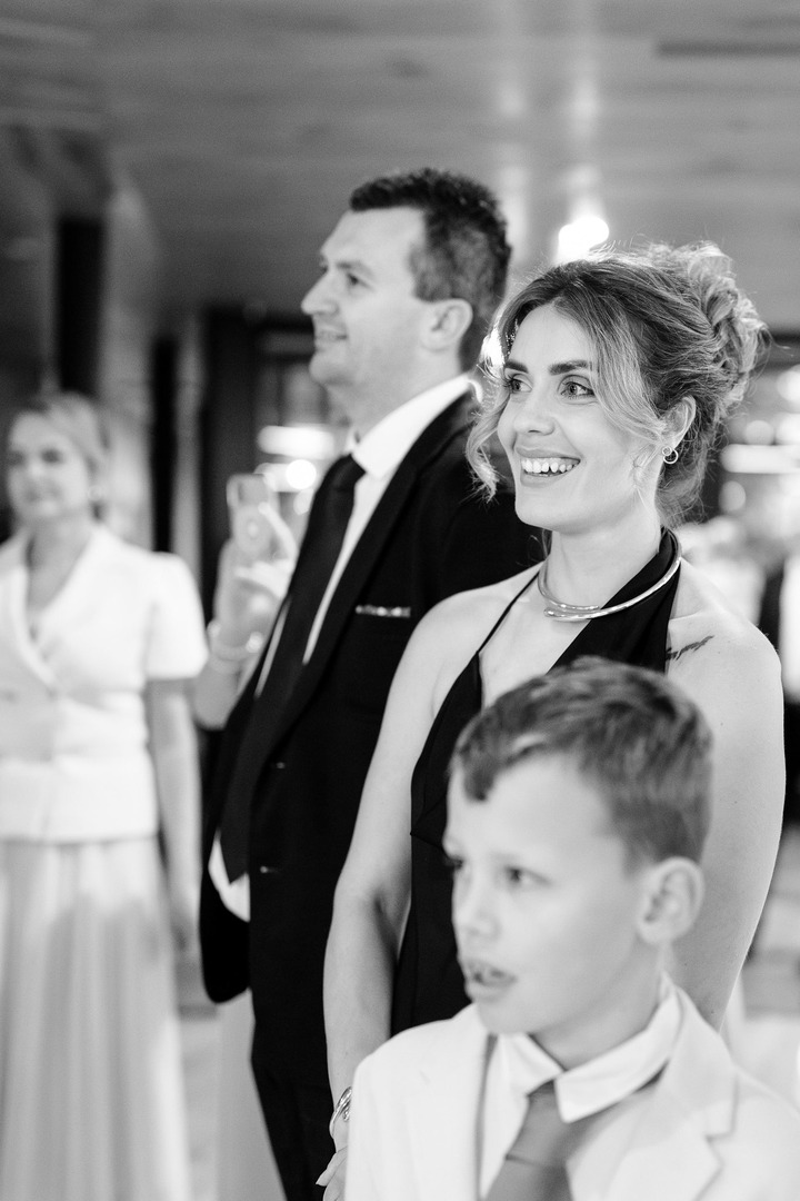 Guests laughing at the newlyweds’ first wedding traditions.
