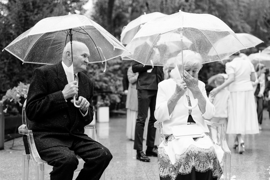 A black-and-white photograph of the bride's grandmother, moved to tears.
A black-and-white photograph of the bride's grandmother, moved to tears.
